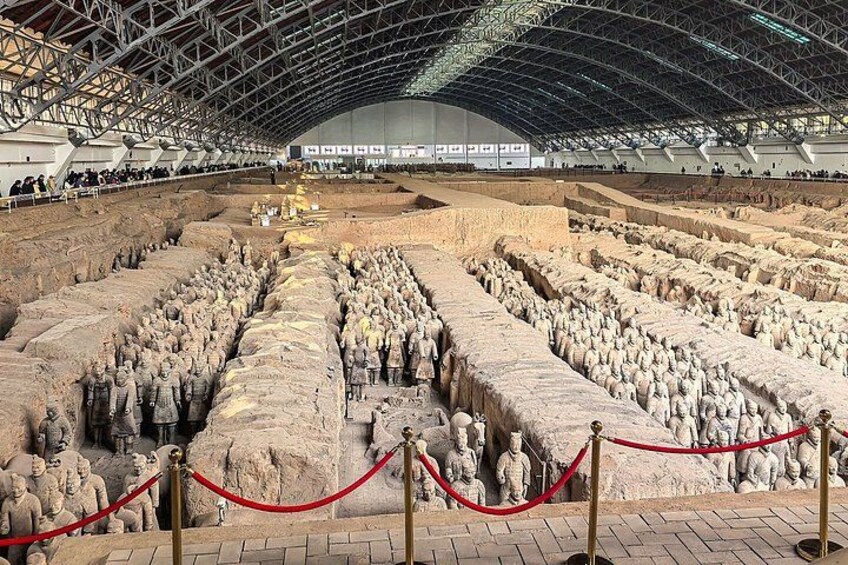 A large open-air museum with rows of terracotta warrior statues. 4