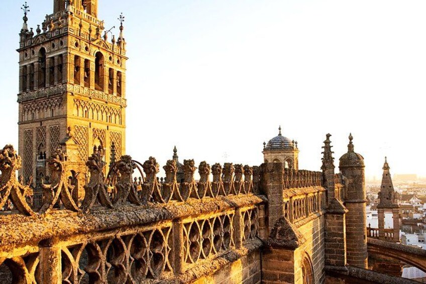 A historic bridge with ornate lion statues, a tower, and a cityscape in the background. 5