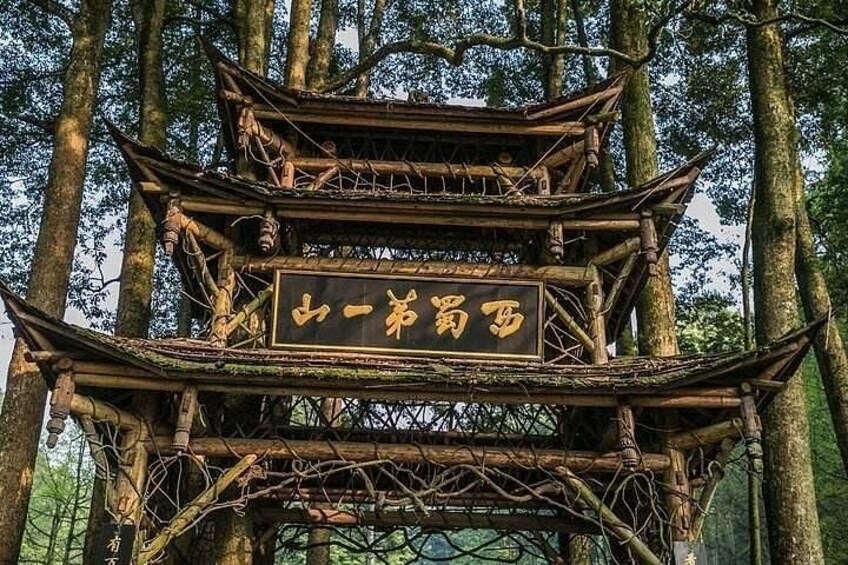 A traditional multi-tiered wooden structure with Chinese characters, surrounded by trees. 4