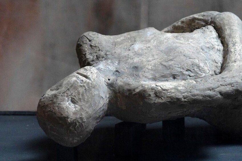 A stone sculpture with a rough texture, possibly depicting a human figure or animal. 2