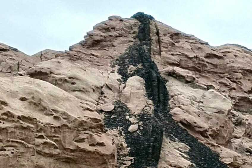 A rocky mountain with a prominent vertical crack. 4