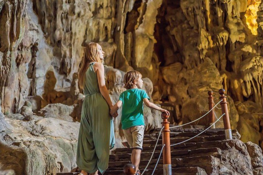 A woman and a child in a cave with stalactites. 2