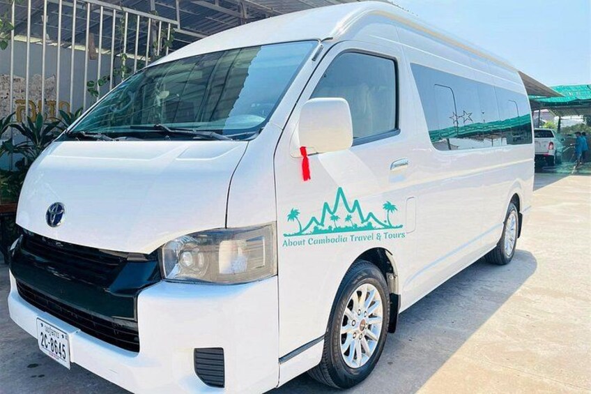 A white van with 'Abroad Cambodia Travel & Tours' branding parked outdoors. 2