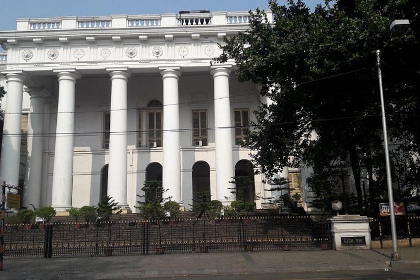 A classical building with columns and arched windows. 5
