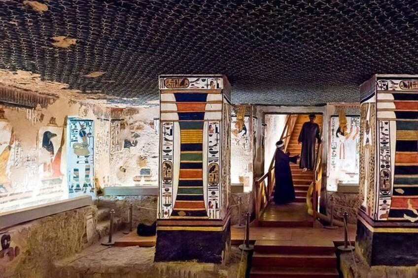 An ancient Egyptian tomb with hieroglyphs and a statue. 3