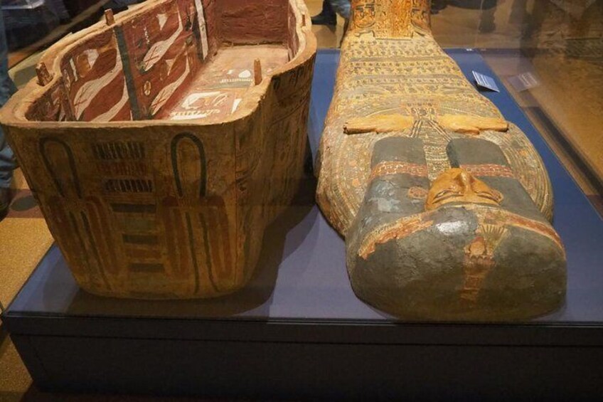 An ancient Egyptian sarcophagus and a mummy in a museum display. 2