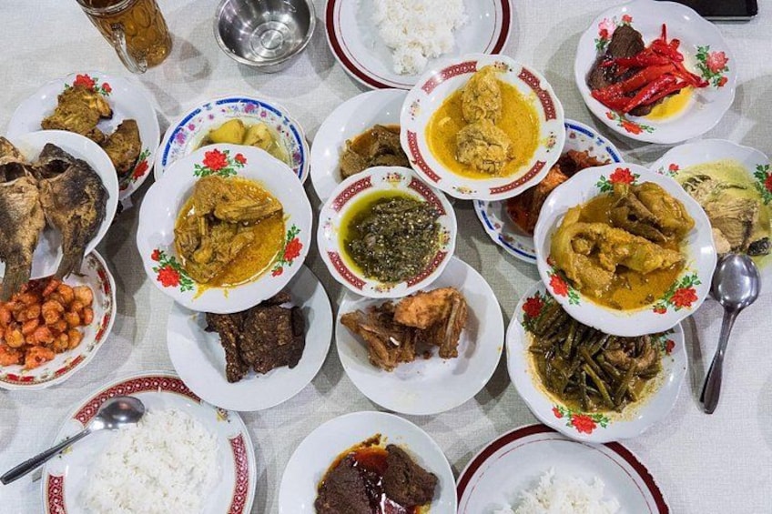 A table with various dishes including rice, meat, and vegetables. 4
