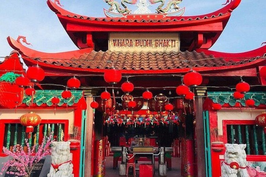 A traditional red and green temple with a sign reading 'Vihar Budhe Bhakt'. 5