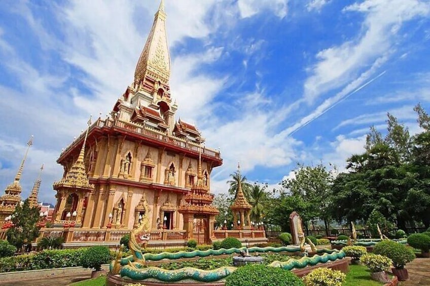 A temple with a pointed spire, intricate architecture, and a well-maintained garden with various plants. 5