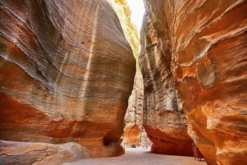 A narrow canyon with layered rock formations. 4