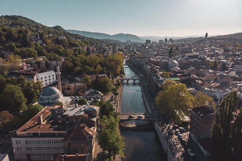 A cityscape with a river, bridges, and a mosque. 2
