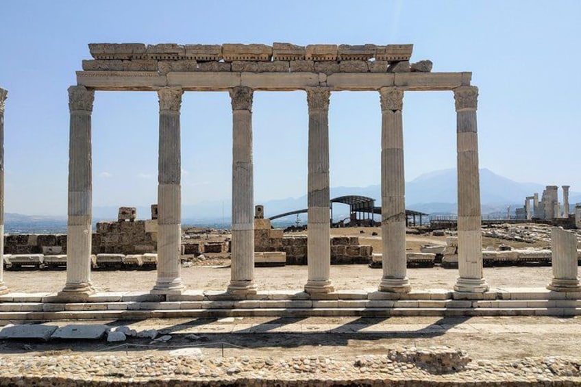 Ancient ruins with columns and stone structures. 4