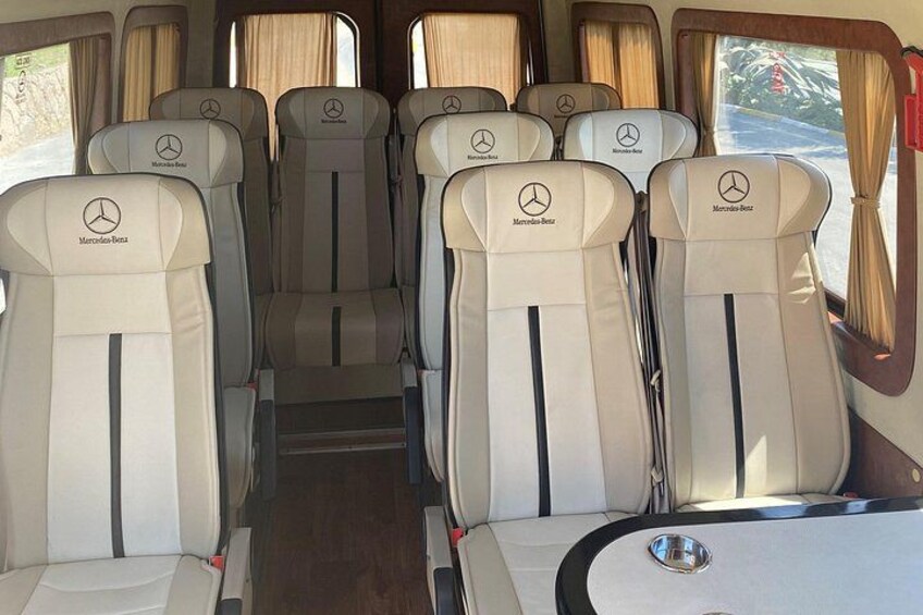 A row of Mercedes-Benz seats with headrests and a central aisle. 5
