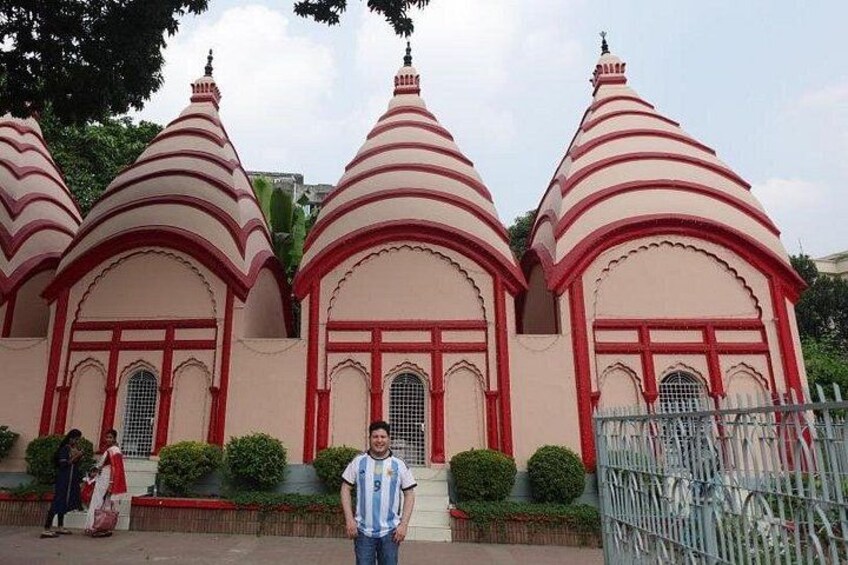 A temple with three domes, each with a red and white striped pattern. 2