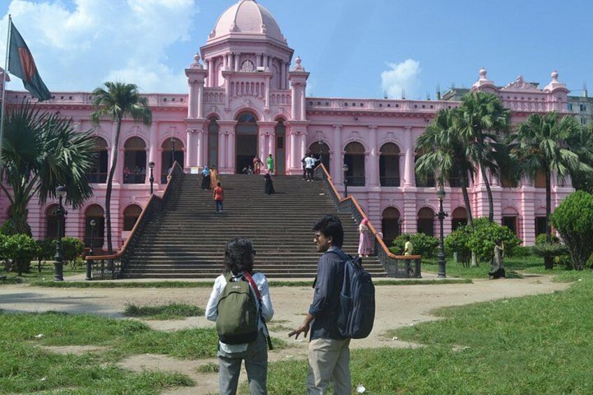 A pink building with a dome and steps leading up to it. 5