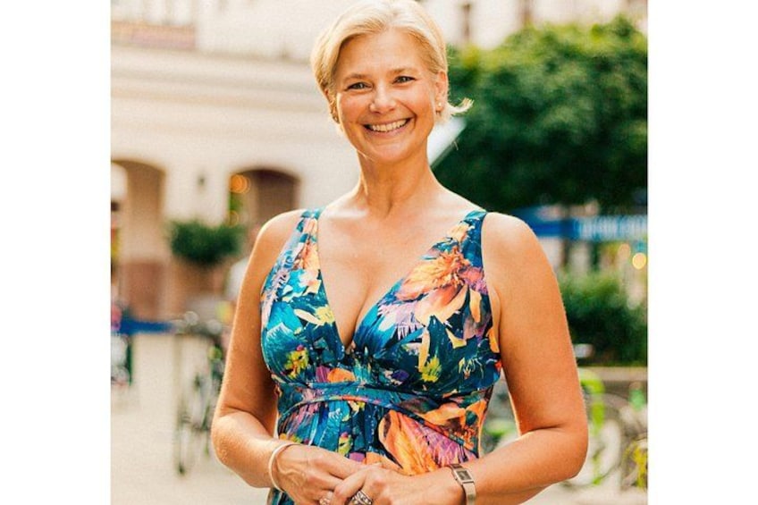 A person wearing a floral dress standing outdoors. 1
