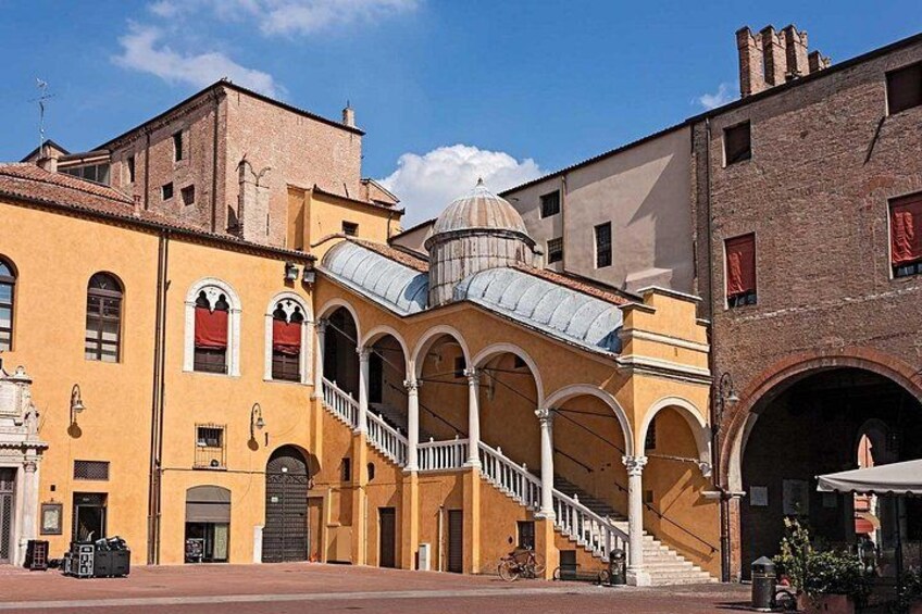 A historic building with a dome, arches, and a staircase. 2