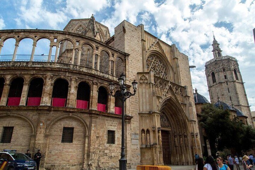 A historic cathedral with a prominent bell tower and a large arched entrance. 2
