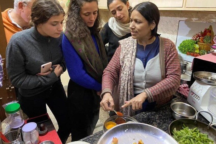 Un groupe de personnes qui cuisinent ensemble dans une cuisine. 1