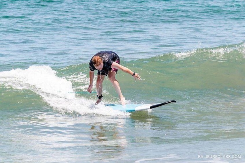 A person surfing on a wave in the ocean. 4