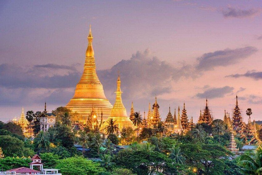 A golden pagoda surrounded by lush greenery and smaller structures. 3