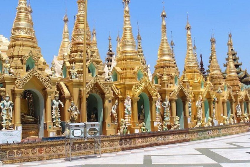 A row of golden pagodas with intricate designs and statues. 1