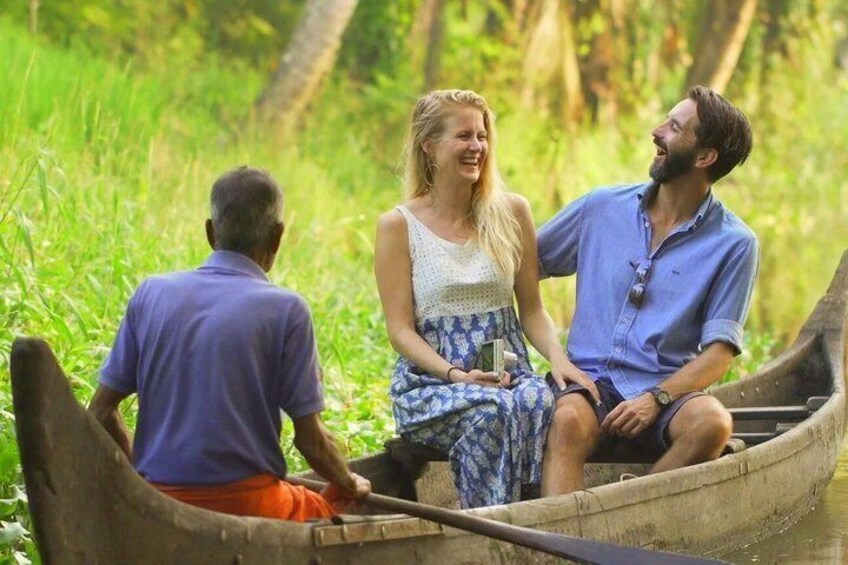 Three people in a canoe on a river surrounded by greenery. 1