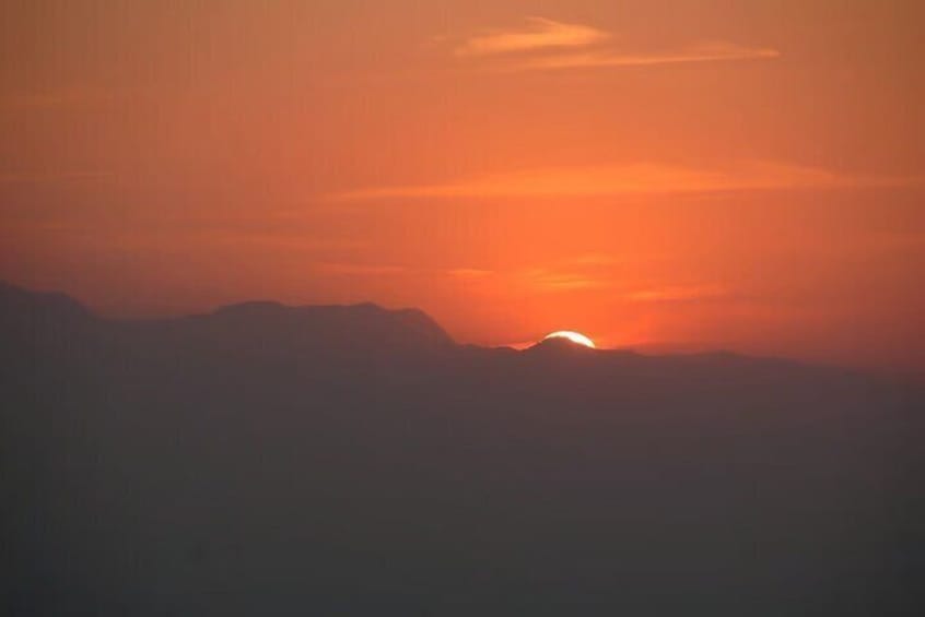 A sunset over a mountain range. 1