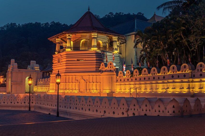 A well-lit, ornate pavilion with a domed roof, surrounded by a decorative wall with pointed arches. 2
