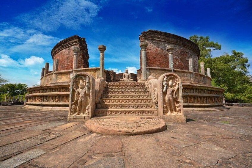 An ancient stone structure with a circular base and a staircase leading up to a platform. 2