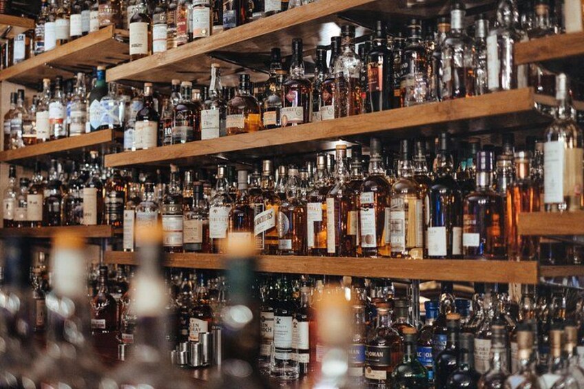 Shelves stocked with various liquor bottles. 5