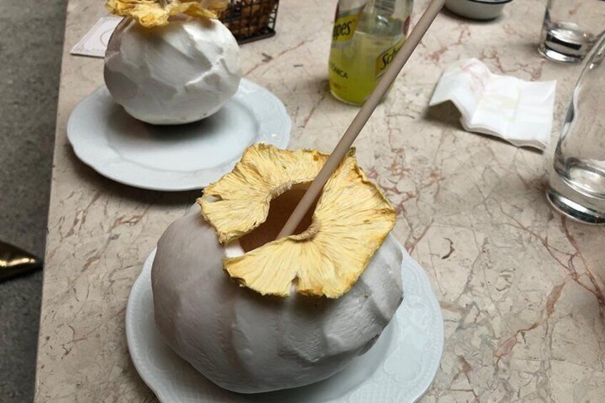 A dessert with a pineapple slice on top, placed on a plate. 1