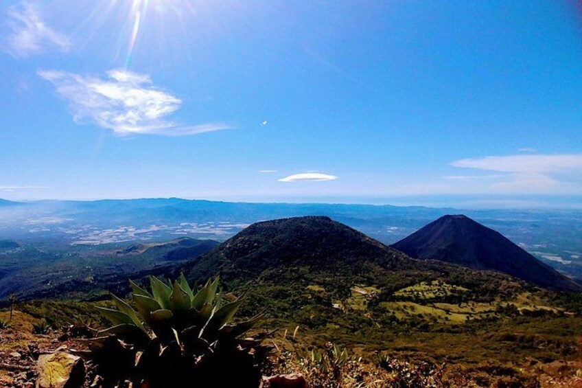 A mountain landscape with a clear sky and distant city view. 2