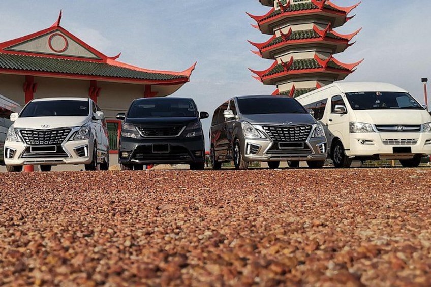 Four cars parked in front of a traditional pagoda-style building. 5