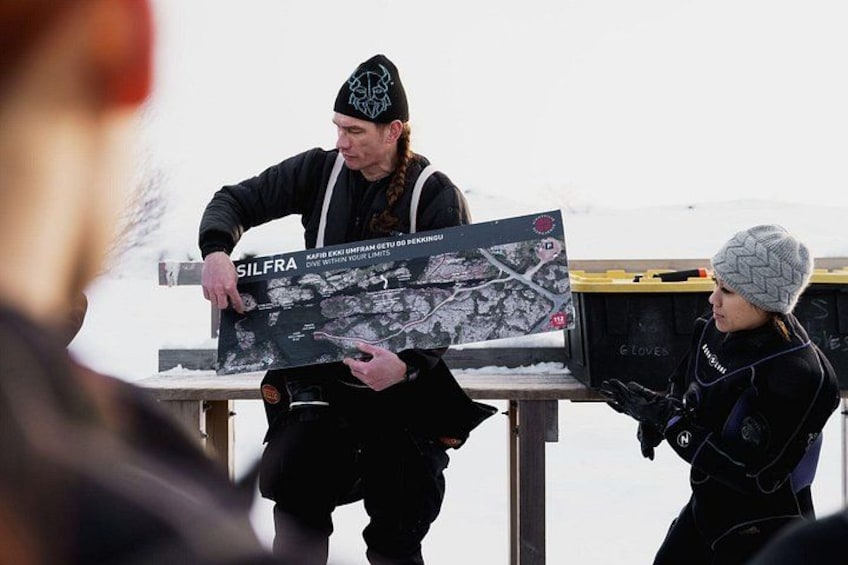 A person holding a map with the text 'SILFRA' on it. 3