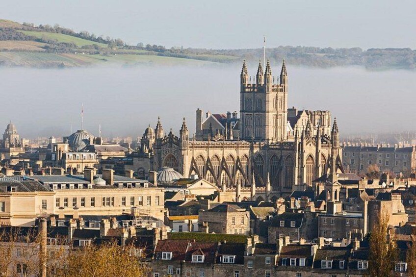 A historic cathedral with Gothic architecture, surrounded by a cityscape with various buildings. 4