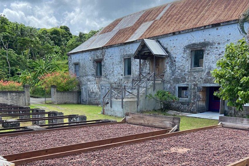 A rustic building with a corrugated metal roof, surrounded by a gravel area with railway tracks. 2