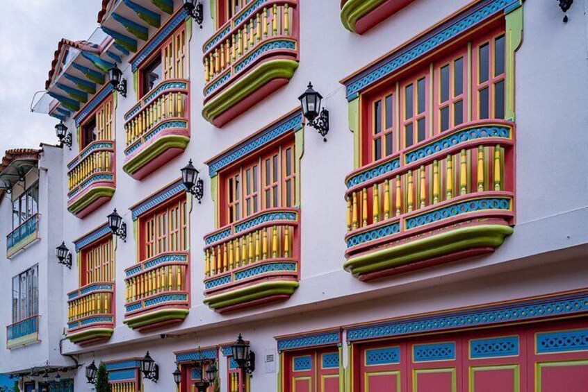 A building with colorful balconies and windows. 2