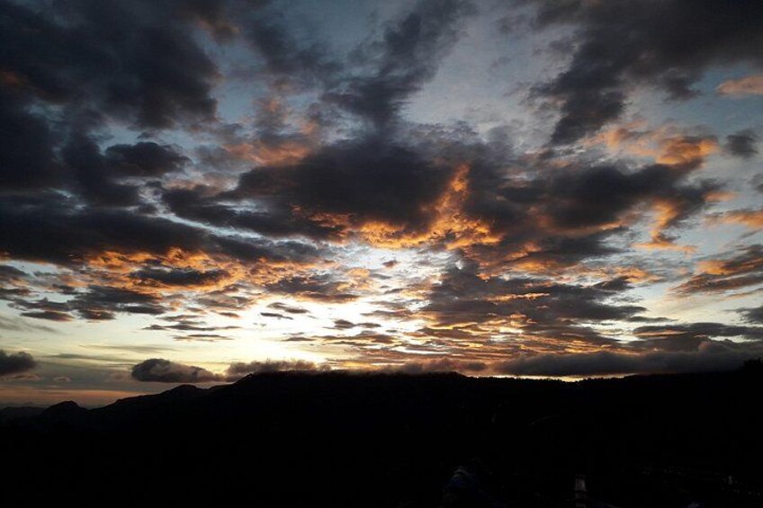 A sunset with clouds over a mountainous landscape. 5