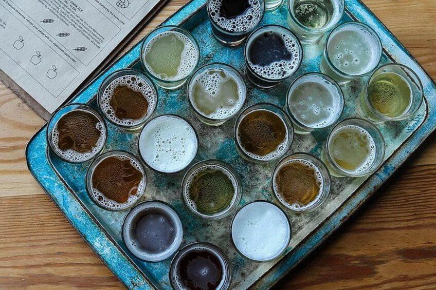 A tray with various colored liquids in small containers. 4