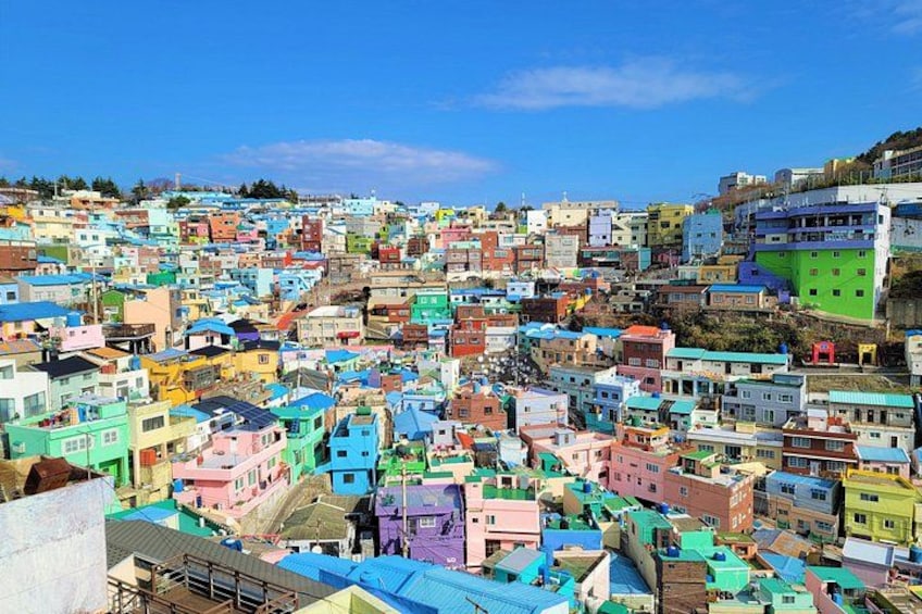 A densely packed hillside town with colorful buildings. 5