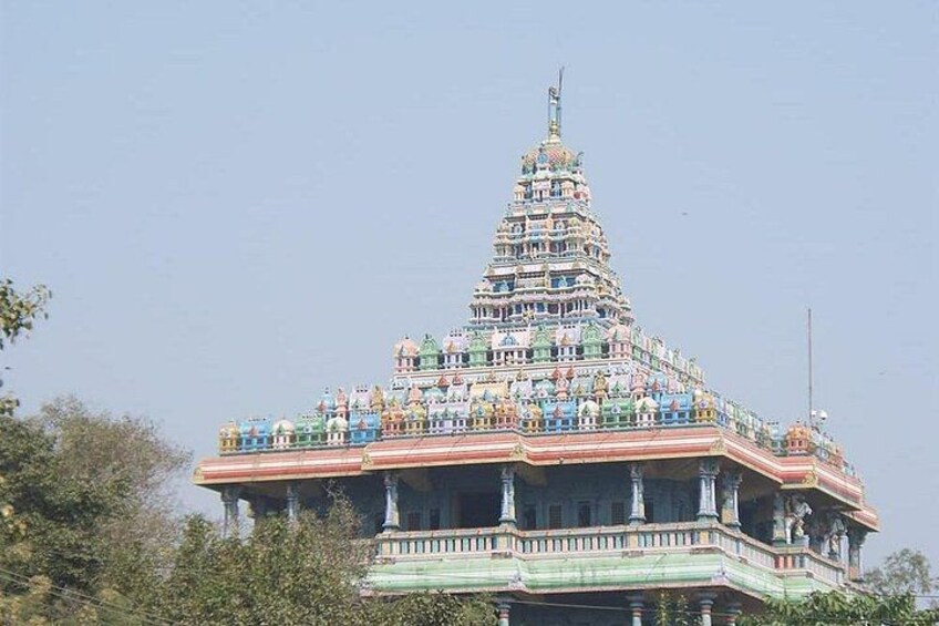 A multi-tiered temple with intricate architecture and multiple statues. 5