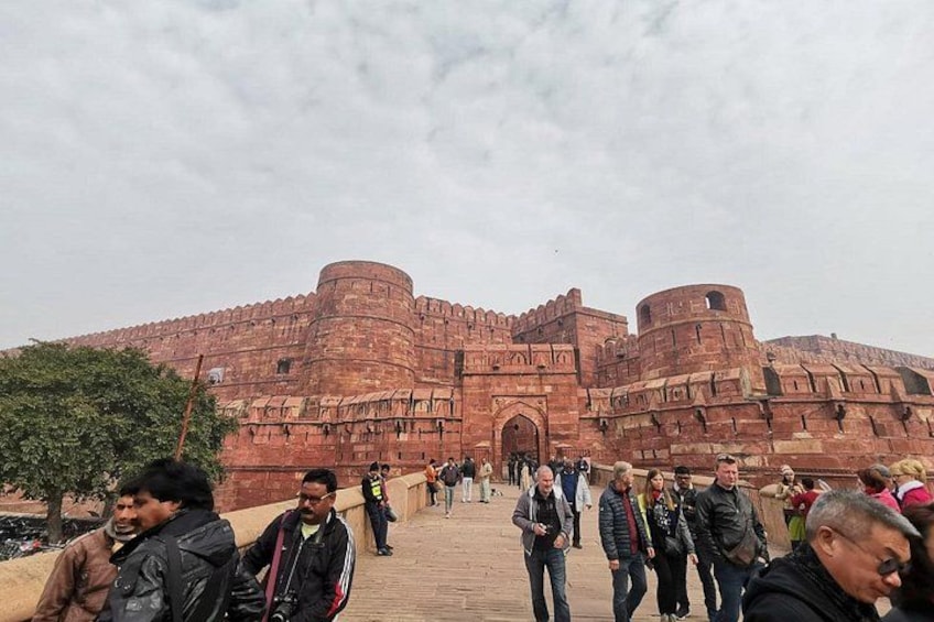 A large red fort with multiple towers and a central entrance. 2