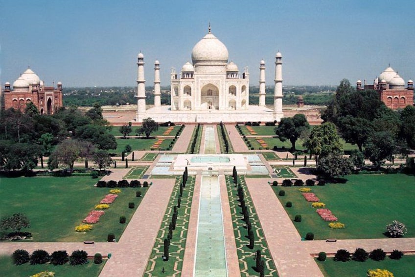 The Taj Mahal with four minarets, a large central dome, and a symmetrical garden layout. 3