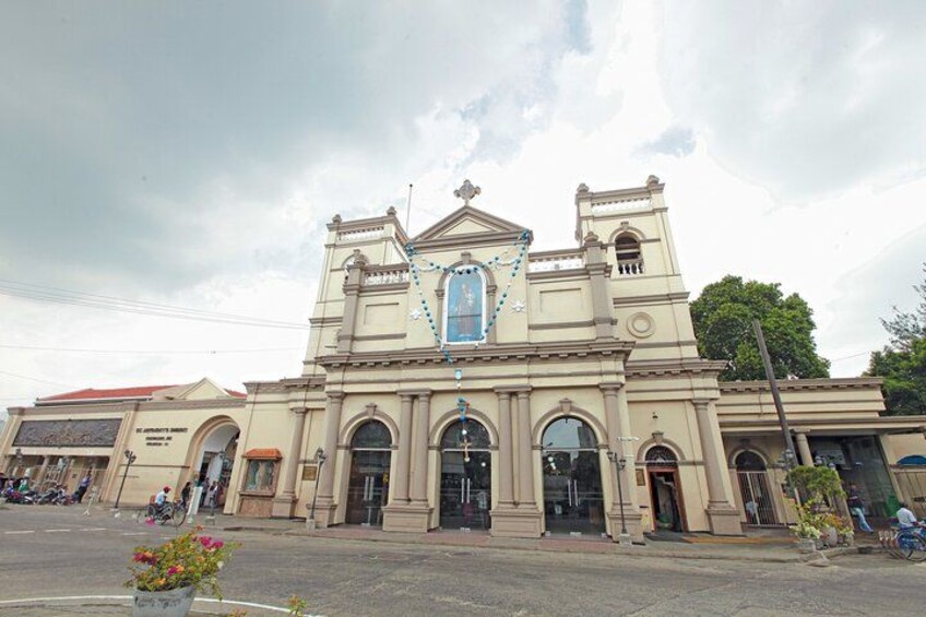 A large, historic building with a central dome, arched windows, and a bell tower. 5