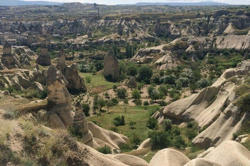 A landscape with prominent rock formations and sparse vegetation. 1