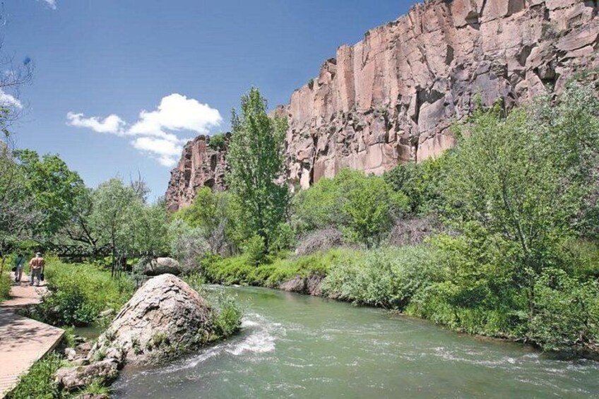 A river flowing through a canyon with rocky cliffs and green vegetation. 3