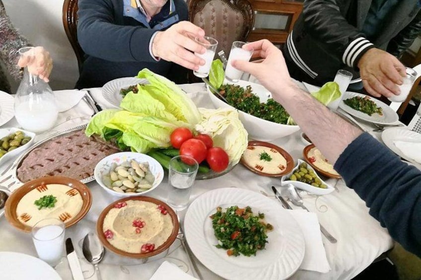 A table with various dishes, including salads, meats, and dips. 1