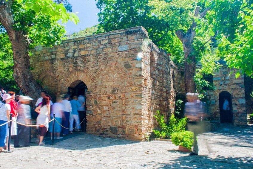 A stone archway, a tree, and a pathway. 2