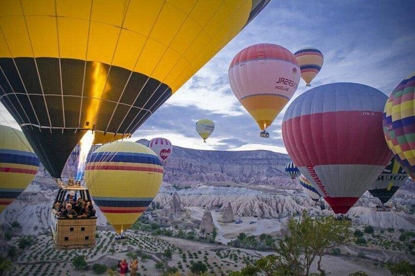 Hot air balloons over a rugged landscape. 4